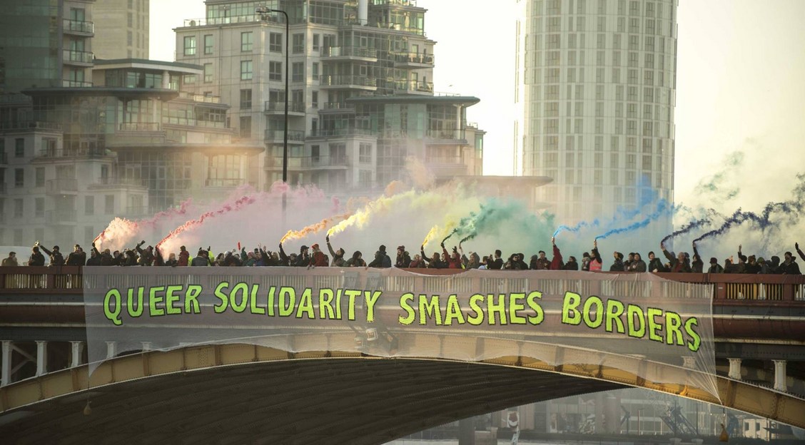 Marchers holding a banner that reads "Queer Liberation Not Rainbow Capitalism" during Dublin Pride 2016