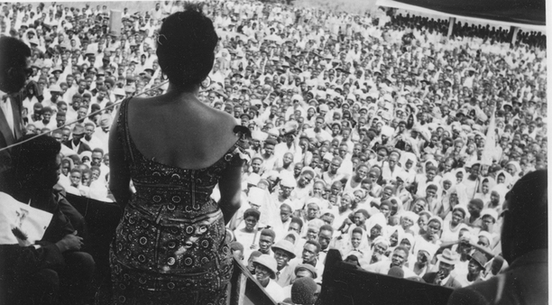 [Photo: Andrée speaking to the crowds at a rally. Idiofa, Belgian Congo, 1960]